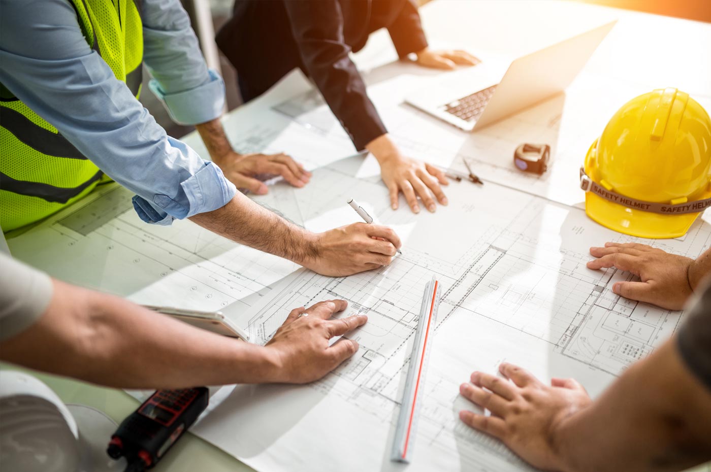 Construction managers reviewing architectural plans